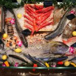a display of fresh fish and vegetables for sale.