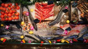 a display of fresh fish and vegetables for sale.