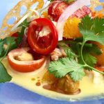 a blue plate topped with meat and vegetables.