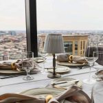 a table set for two with a view of the city.