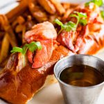 a white plate topped with a sandwich and french fries.