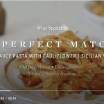 a white plate topped with pasta covered in sauce.