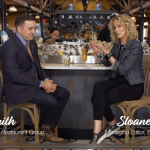 a man and a woman sitting at a bar.