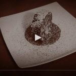 a white plate topped with a chocolate dessert.
