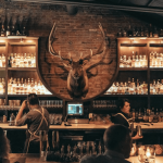 a group of people sitting at a bar.