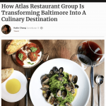 a plate of food on a table with a glass of wine.