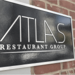 a restaurant sign on the side of a building.