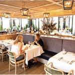 a couple of women sitting at a table in a restaurant.
