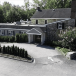 an aerial view of a house with a car parked in front of it.