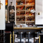 A bar in a restaurant with a lot of bottles.