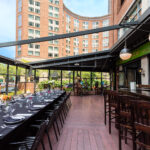 An outdoor dining area with tables and chairs.