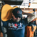 A man with a guitar on his head.