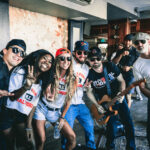 A group of people posing for a photo in a bar.