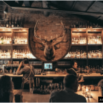 a group of people sitting at a bar.