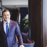 a man in a suit and tie standing in a room.