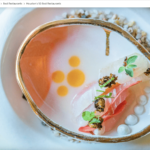 a white plate topped with food on top of a table.