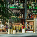 a bar filled with lots of bottles of alcohol.