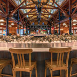 a large round table with wooden chairs around it.