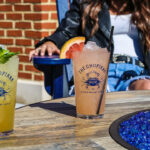 a couple of drinks sitting on top of a wooden table.