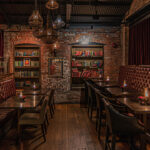 a dimly lit restaurant with a brick wall.