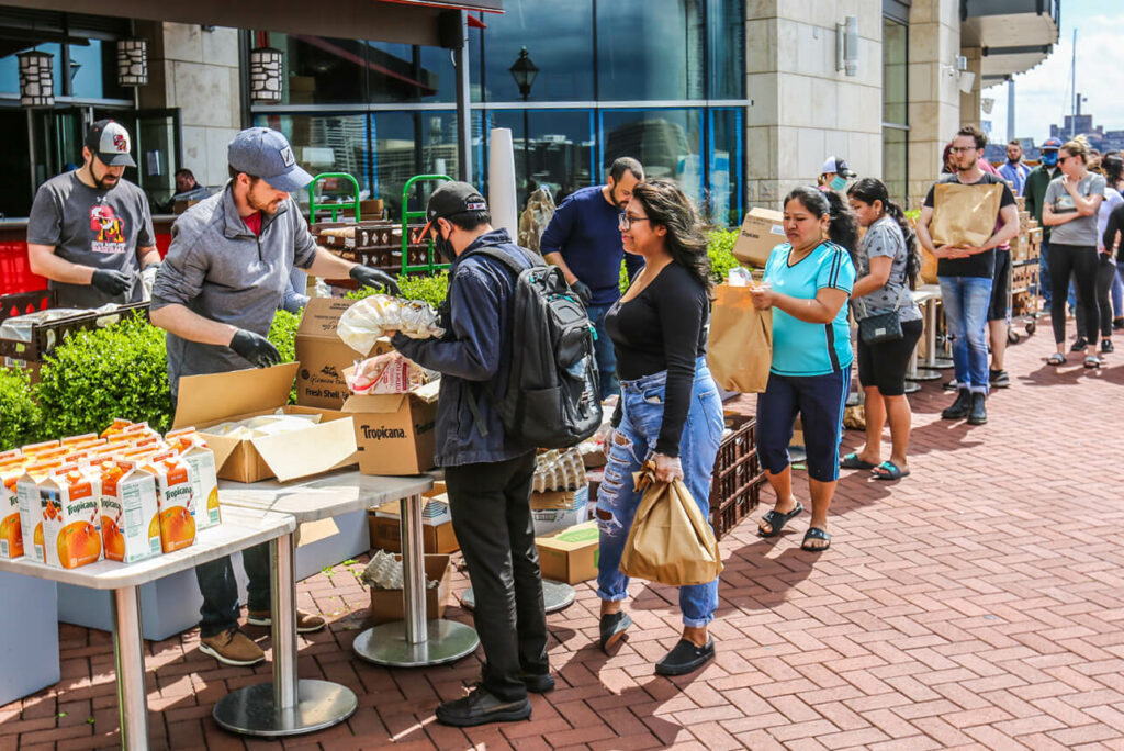 a group of people standing outside of a store.