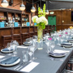 a long table with a vase of flowers on top of it.