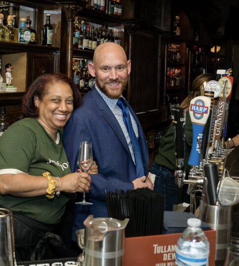 Employees having fun behind the bar