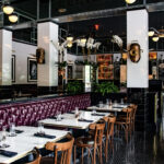 a restaurant with tables and chairs and a bar.