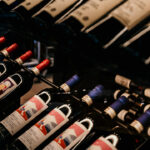 a bunch of bottles of wine sitting on top of a table.
