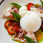 a white plate topped with fruit and ice cream.