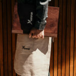 a person holding a bag with a name on it.