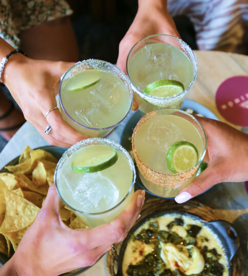a group of people holding glasses of drinks.