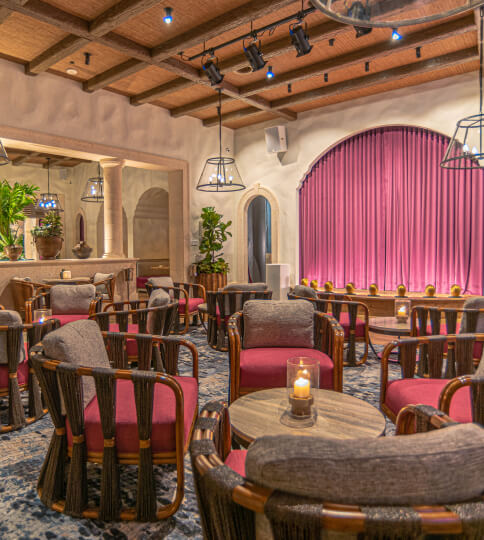 a restaurant filled with lots of tables and chairs.
