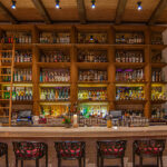 a bar with a lot of bottles on it.