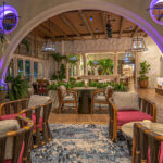 a room filled with lots of chairs and tables.