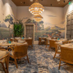 a restaurant with a mural on the wall.