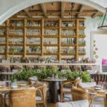 a restaurant with wicker chairs and tables.