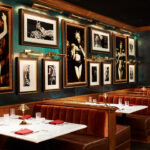 a dining room with a lot of pictures on the wall.