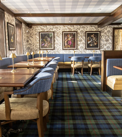 a long table with chairs and a bench in a room.