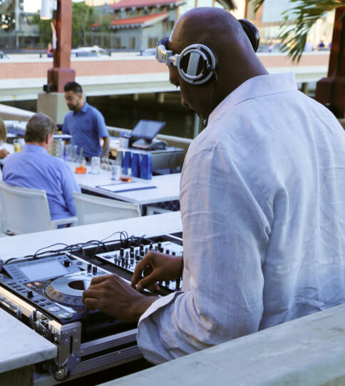 a man with headphones is playing a dj set.