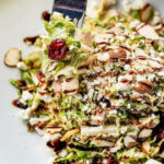 a white plate topped with a salad and a fork.