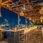 a restaurant with a view of a city at night.