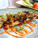 a plate of food on a wooden table.