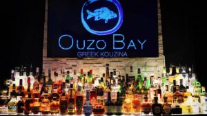 a large display of liquor bottles in front of a sign.