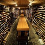 a long wooden table in a wine cellar.