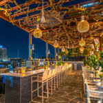 a restaurant with a view of a city at night.