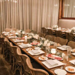 a long table with plates and place settings on it.