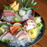 a couple of bowls filled with different types of food.