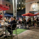 Evening diners enjoying the outdoor seating at Loch Bar Boca Raton