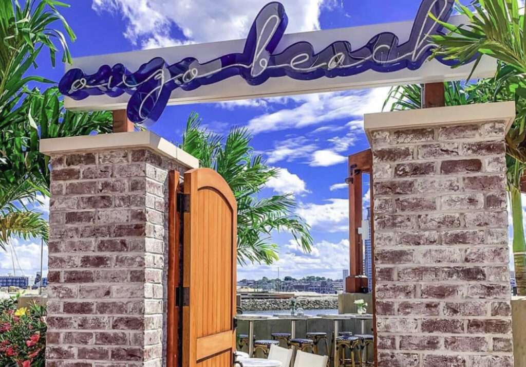 the entrance to a restaurant with a sign above it.